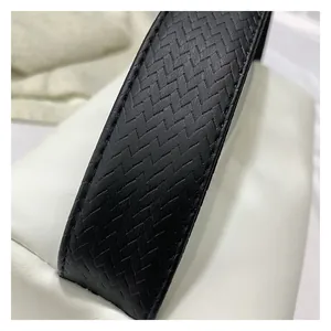 Detailed close-up showing the premium black woven leather texture and stitching on the strap