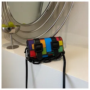 Close-up of a mini geometric color-block crossbody bag with black chain and dual straps