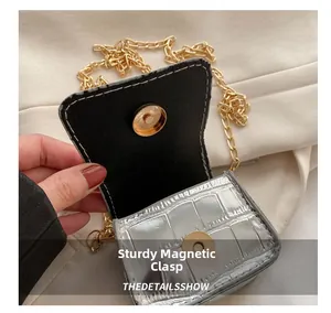 Detail showing the sturdy golden magnetic snap and silver stone pattern texture on a mini bag