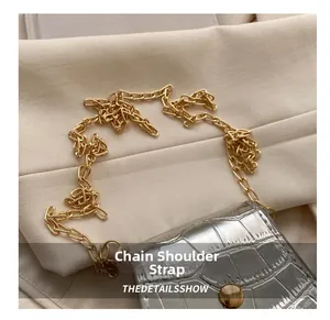 Detailed close-up of a silver crocodile texture mini bag with a golden chain strap