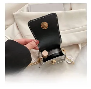 Detailed interior of a stone-patterned mini flap bag holding a lipstick and powder box