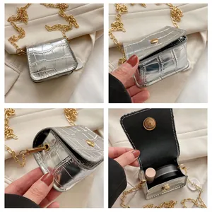 Detail showing mini silver stone-pattern bag with gold chain and interior lipstick storage