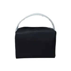 Minimalist black tote bag with light blue handles shown against a plain white background