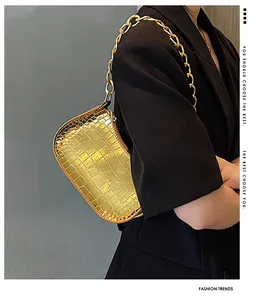 Close-up of golden metallic hobo bag with crocodile texture and chunky chain strap