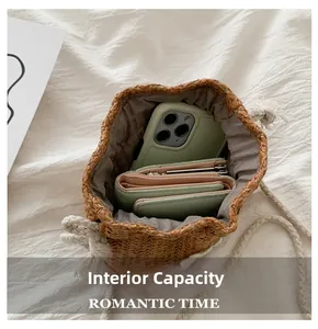 Internal capacity of the straw bucket bag showing phone and wallet inside