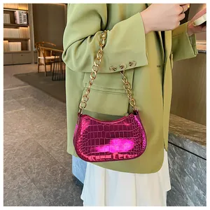 Detail of fuchsia metallic hobo bag with croc pattern and chunky gold chain strap
