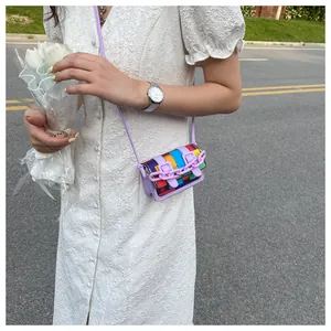 Outdoor lifestyle shot of a mini rainbow patchwork crossbody bag with purple chain