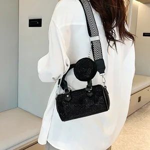 Detail of black rhinestone cylinder bag with a wide herringbone strap and round coin purse