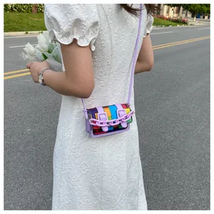 Mini purple crossbody bag with colorful patchwork flap and plastic chain on a model