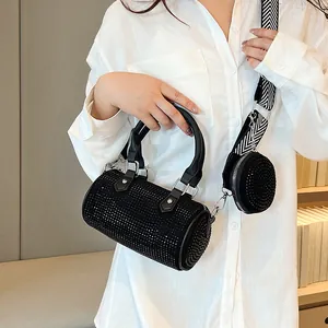 Detail of black rhinestone barrel bag with geometric wide strap and small round coin purse