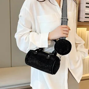 Detail of rhinestone black cylinder bag with matching mini pouch and geometric strap