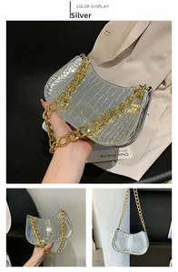 Silver glossy crocodile pattern underarm bag with thick gold chain handle and zipper detail