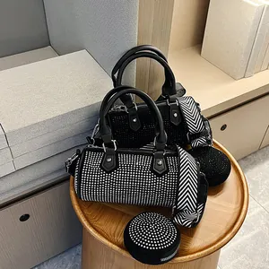 Close-up of sparkling rhinestone barrel bags with stylish herringbone straps and mini pouch