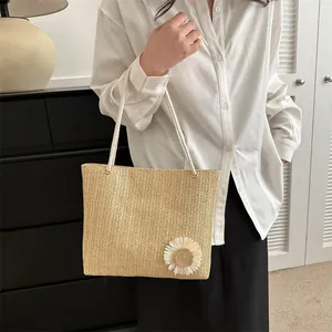 Chic woven straw tote bag with a white floral ornament and rope handle for women