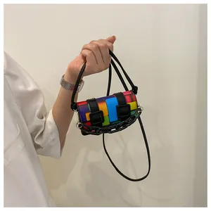 Close-up of mini geometric crossbody bag with vibrant color blocks and black chain detail