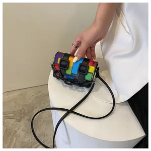 Detail of colorful patchwork mini crossbody bag with black plastic chain decoration