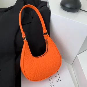 Fashionable orange felt crescent shoulder bag with crocodile texture and gold hardware