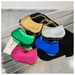 Close-up of five metallic hobo bags in assorted colors with chunky gold chain handles