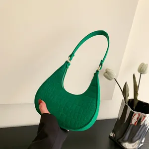 Emerald green felt crescent bag with crocodile pattern and golden metal hardware