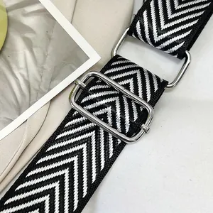 Close-up of adjustable black and white chevron woven strap with silver metal buckles