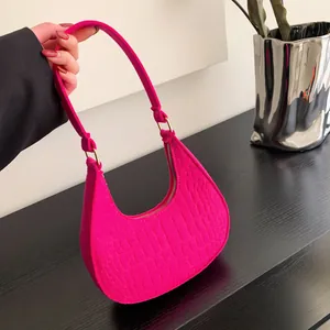 Fashionable magenta crescent moon shoulder bag with crocodile pattern and gold hardware