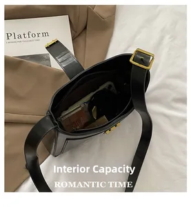 Internal capacity of the black bucket bag showing phone, lipstick and cosmetics