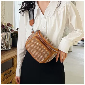 Détail du sac de poitrine en daim marron avec strass et bandoulière tissée large
