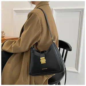 Detail of black leather bucket bag with gold square buckle and Fashion & Bag text
