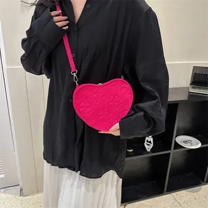 Fashionable heart-shaped crossbody bag for women in rose red felt with embossed clover patterns