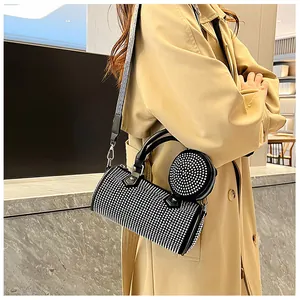 Black rhinestone barrel bag with geometric strap and matching round coin pouch