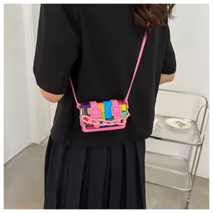 Detail of colorful geometric mini crossbody bag with pink chunky chain and shoulder strap