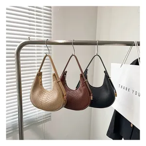 Detailed close-up showing beige, brown, and black crocodile texture shoulder bags