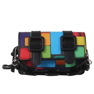Mini geometric patchwork shoulder bag with vibrant color blocks and black strap details