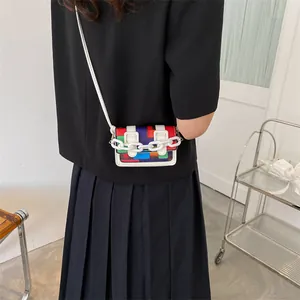 Mini geometric patchwork crossbody bag with white chain strap and magnetic flap closure