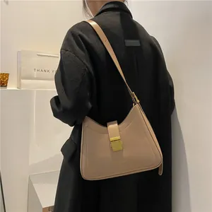 Chic beige leather bucket shoulder bag for women with golden metal buckle clasp