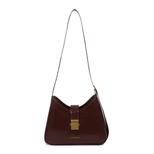 Classic burgundy leather bucket bag with vintage gold buckle and shoulder strap