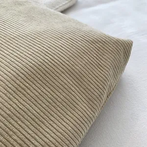 Detailed macro shot of beige corduroy fabric texture for large capacity tote bag