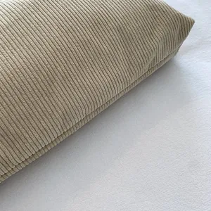 Detailed view of thick corduroy fabric texture and stitching on a khaki shoulder bag