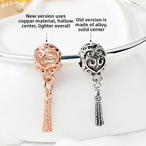 Macro detail comparing lightweight hollow copper heart charm and solid alloy bead