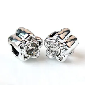 Detailed view of silver flower charm bead with centered rhinestone for DIY jewelry