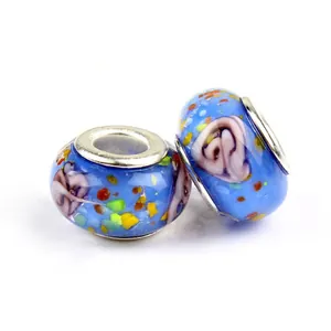 Detailed macro view of sky blue glass charm beads with floral patterns for DIY bracelets