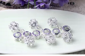 Macro shot of silver hollow ball charms with clear cubic zirconia for DIY jewelry making