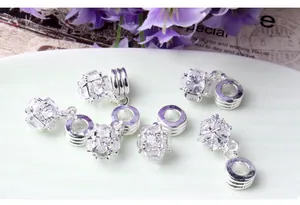 Macro detail of sparkling white zircon sphere charms on elegant ceramic plate
