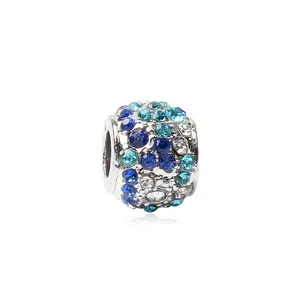 Macro shot of blue crystal pavé charm bead for bracelets with multi-color rhinestones