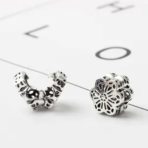 Silver vintage hollow floral charm beads with six-petal flower design for DIY bracelets