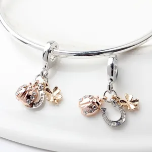 Silver charm bracelet with horseshoe, ladybug, and four-leaf clover crystal pendants
