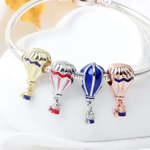 Snake chain charm bracelet featuring four colorful enamel hot air balloon pendants