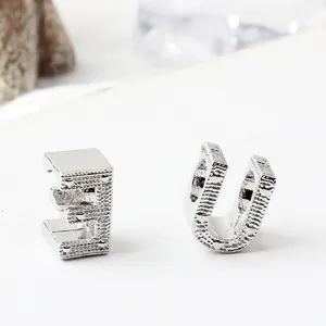 Polished silver alloy alphabet charms featuring letter E and U with hammered textures