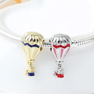 Colorful enamel hot air balloon charms in gold and silver finish on a snake chain bracelet