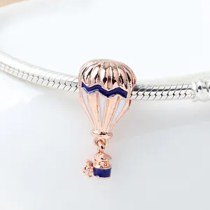 Hot air balloon charm bead in rose gold finish with blue and white enamel detailing